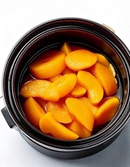 Put canned peaches in a slow cooker with these 3 ingredients. Dessert dreams come true..